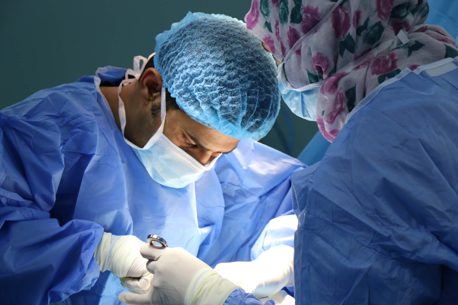 Doctor and Nurse operating on a patient