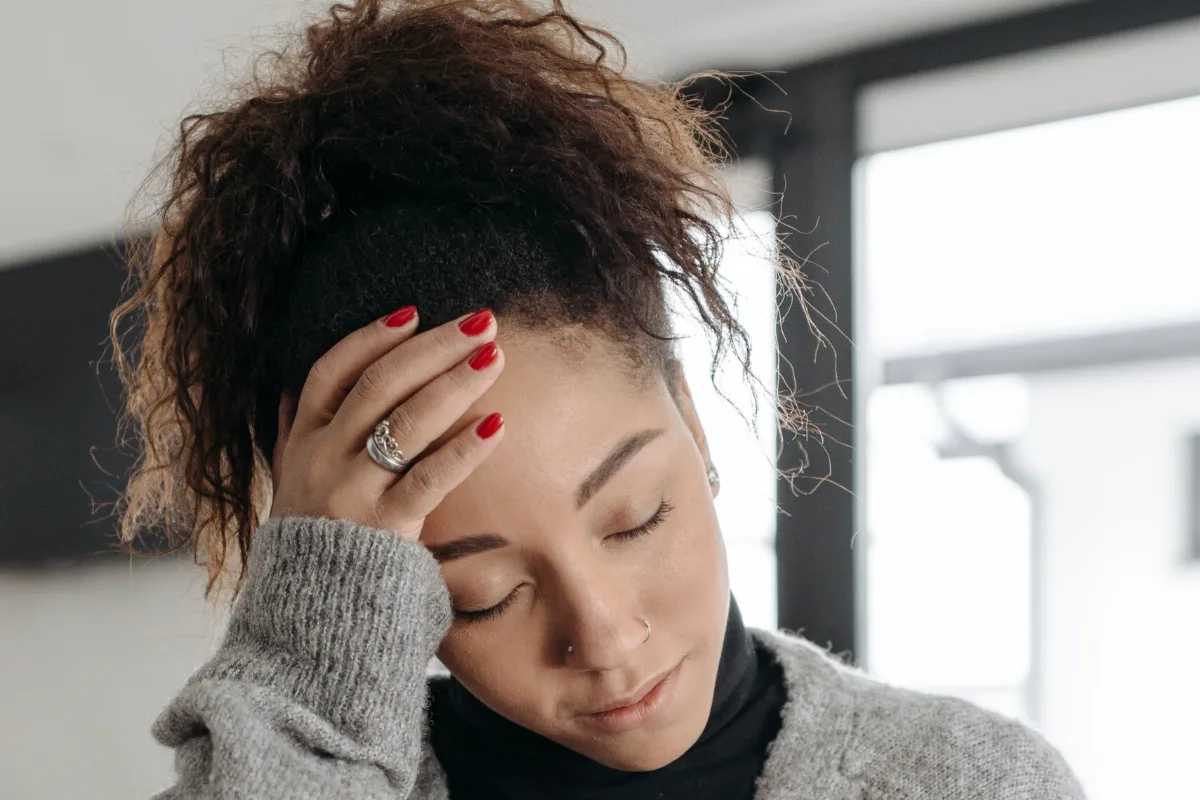 Woman holding her head during a migraine