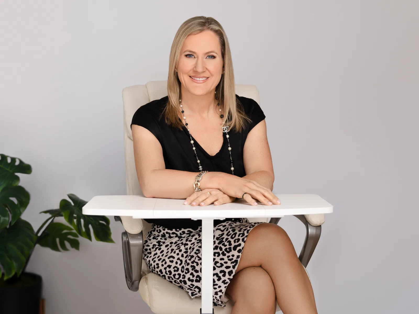 Jennifer Gularson, PA-C at her desk ready for an aesthetics consultation