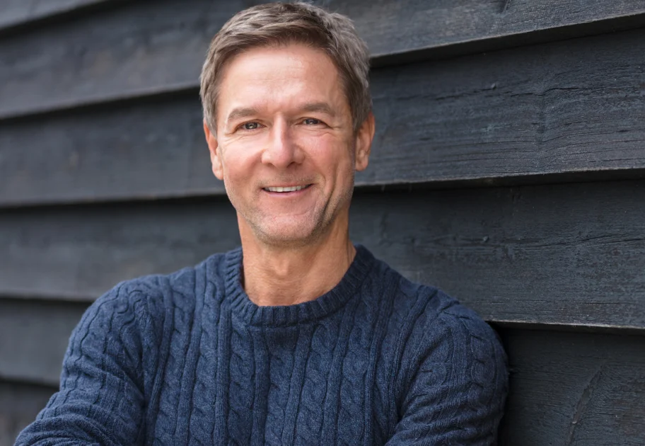 Smiling man in his late 40s in a navy sweater, low testosterone care in Rockville, MD